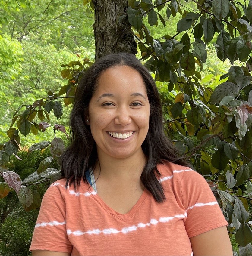 Headshot of Marissa Taylor in front of a tree with bright green leaves