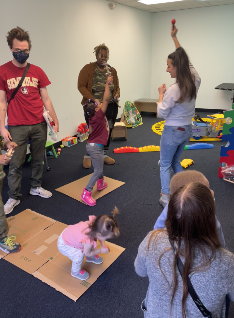 A group of kids dancing and experiencing music therapy