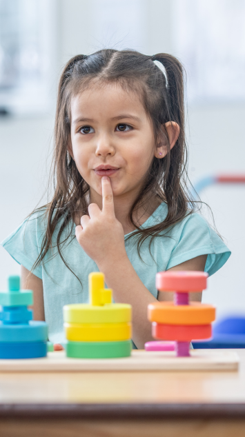 little girl pointing to her mouth to work on sounds